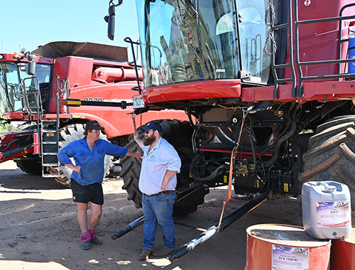 Harry chats with a client in front of two headers